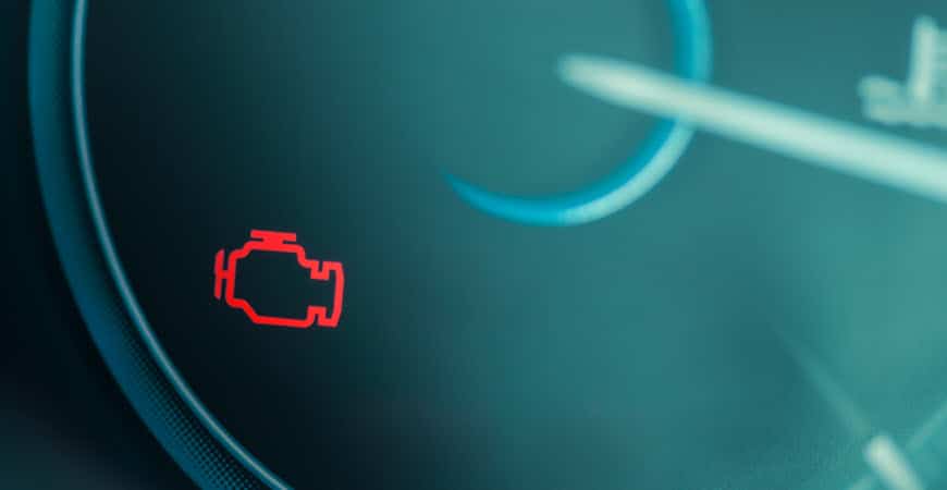 Car dashboard with check engine warning light