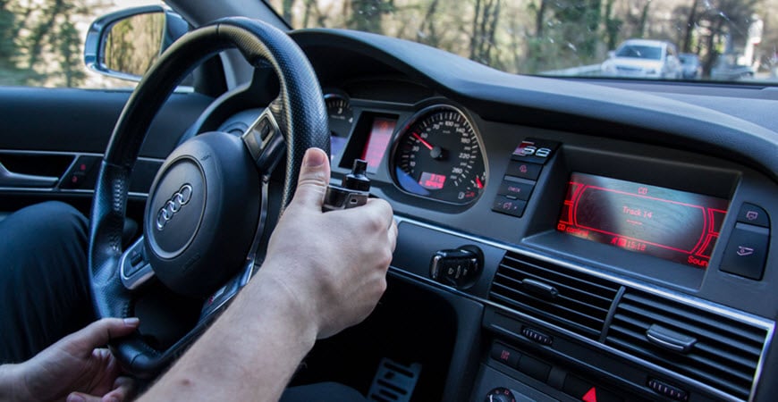 Driver holding steering wheel inside Audi car
