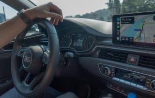 Driver using navigation system in Audi car