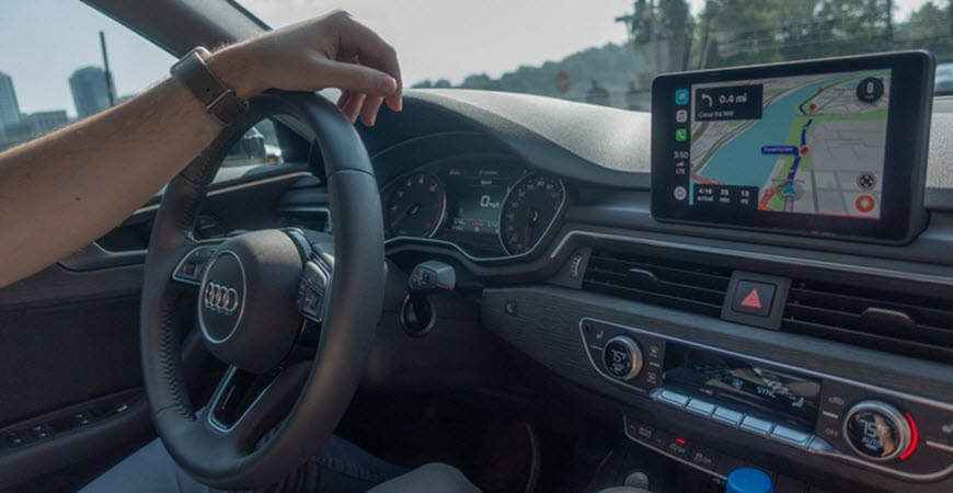 Driver using navigation system in Audi car