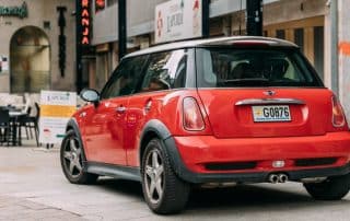 Red Mini Cooper parked on city street