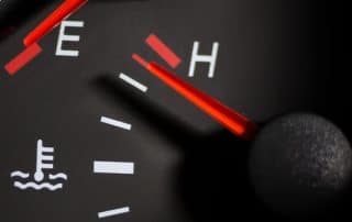 Car temperature gauge needle near hot mark