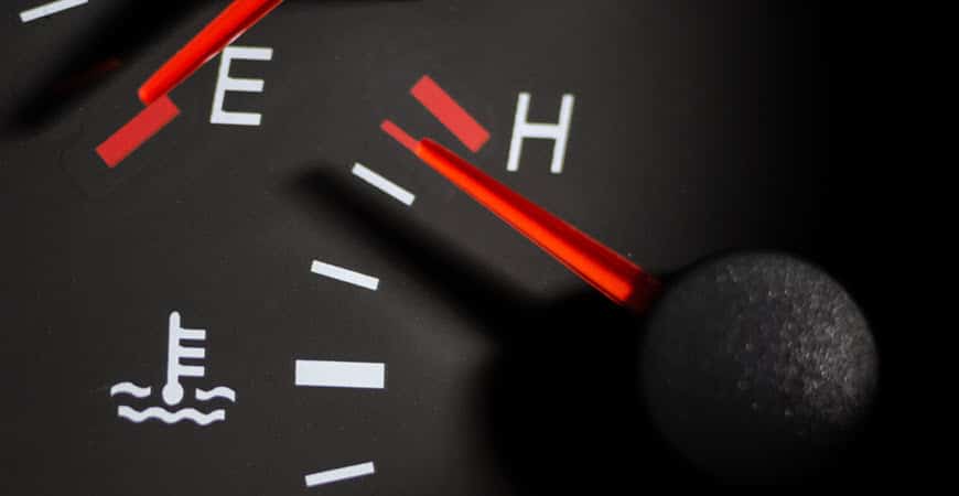 Car temperature gauge needle near hot mark