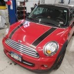Red Mini Cooper with black racing stripes