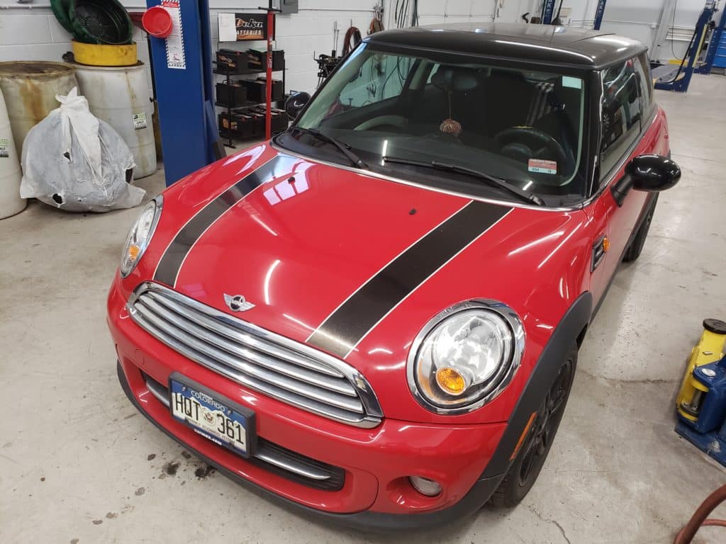Red Mini Cooper with black racing stripes