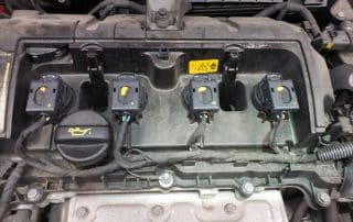 Car engine with four ignition coils visible