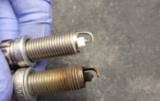 New and used spark plugs side by side
