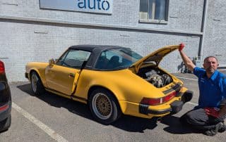 Yellow classic Porsche 911 with open engine