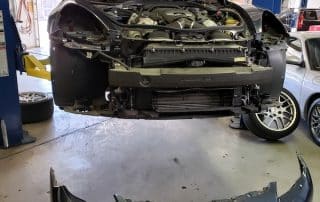 Car on lift with front bumper removed