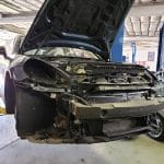 Car on lift with front end removed