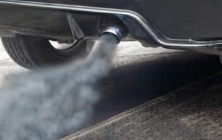 Car exhaust pipe emitting visible smoke