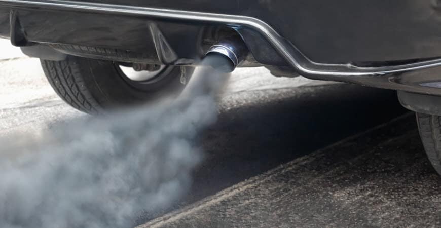 Car exhaust pipe emitting visible smoke