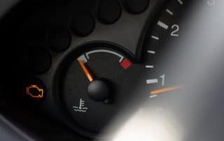 Car dashboard with check engine warning light