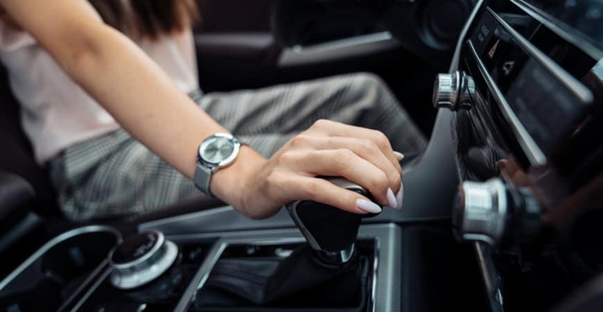 Hand shifting manual gear in modern car