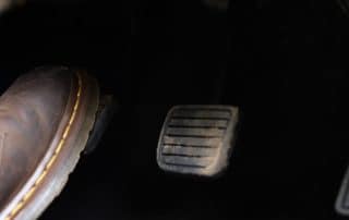 Foot pressing car pedal inside vehicle
