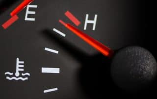 Car temperature gauge needle near hot mark