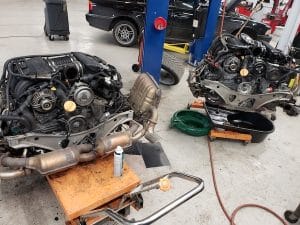 Two car engines in auto repair shop