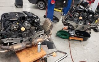 Two car engines in auto repair shop