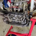 Car engine mounted on red engine stand