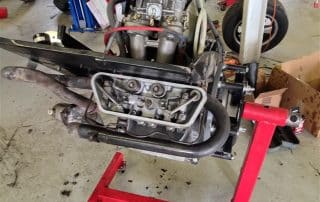 Car engine mounted on red engine stand