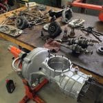 Disassembled transmission parts on workshop table