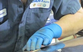 Auto technician polishing a car surface
