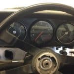 Car dashboard and steering wheel with exposed center hub