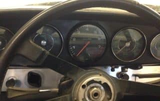 Car dashboard and steering wheel with exposed center hub