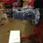 Car transmission mounted on red engine stand