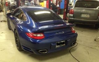 Blue Porsche 911 Turbo S in auto shop