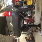 SUV elevated on lift in auto repair shop