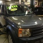 Gray Land Rover SUV in auto garage