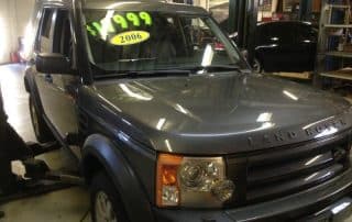 Gray Land Rover SUV in auto garage