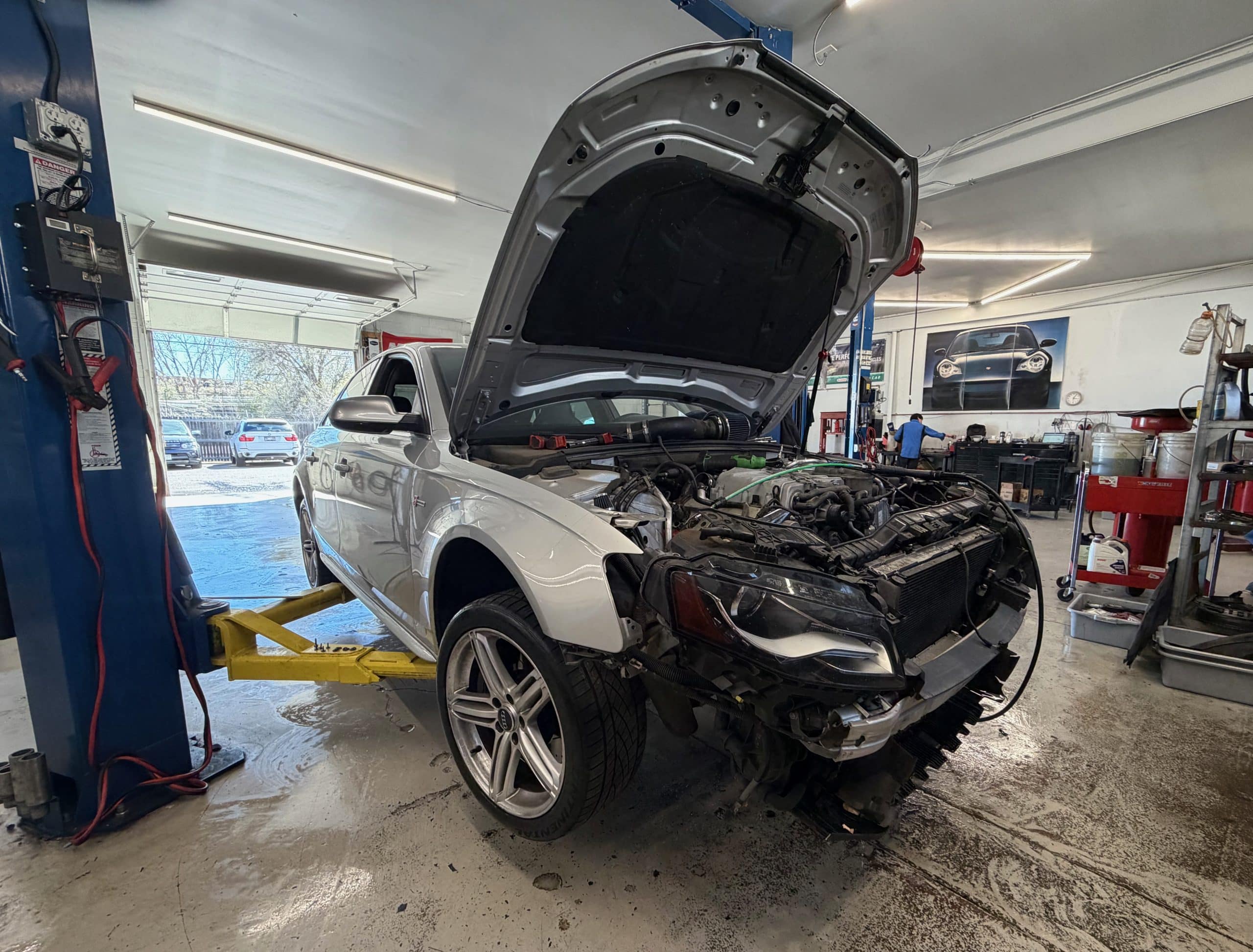 White Audi on lift with hood open