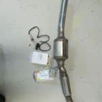 Automotive catalytic converter with oxygen sensor on floor