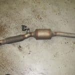 Used catalytic converter with exhaust pipe on floor
