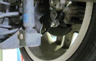 Close-up of car suspension and brake assembly