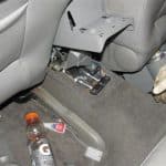 Car interior with exposed device under seat