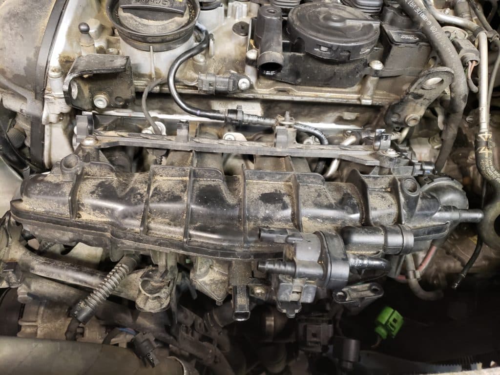 Close-up of dusty car engine intake manifold