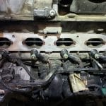 Car engine cylinder head with exposed fuel injectors