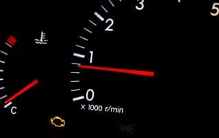 Car dashboard with illuminated check engine light