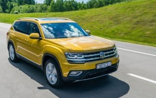 Yellow Volkswagen SUV driving on highway