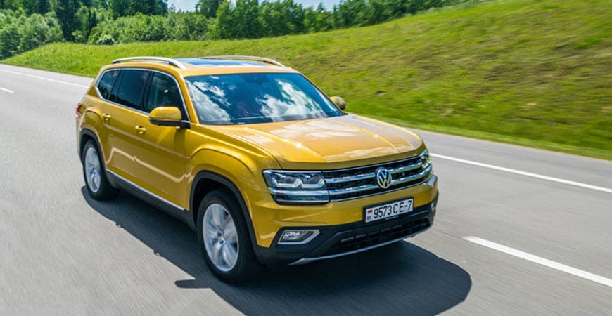 Yellow Volkswagen SUV driving on highway