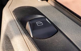 Car window control button on door panel