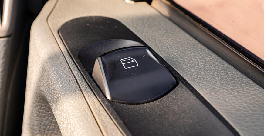 Car window control button on door panel