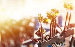Industrial robotic arms with glowing yellow lights