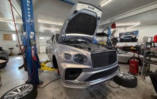 Luxury SUV on lift in auto shop