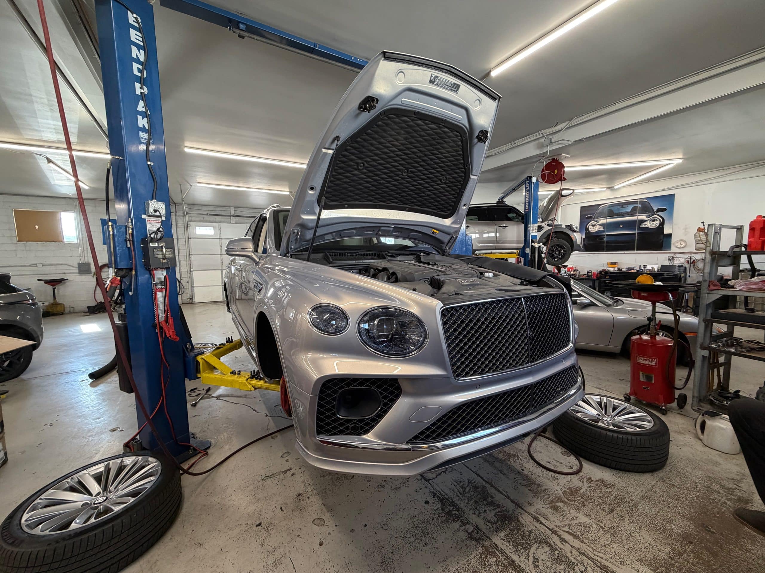 Luxury SUV on lift in auto shop