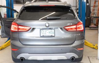 Rear view of silver BMW X7 in garage