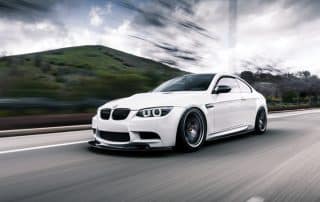 White sports coupe driving on highway